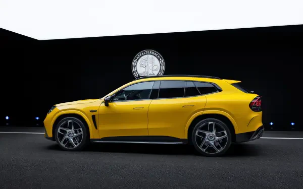 Yellow Mercedes-AMG GT SUV in a dramatic studio setting, 2K Quad HD PC desktop wallpaper background.