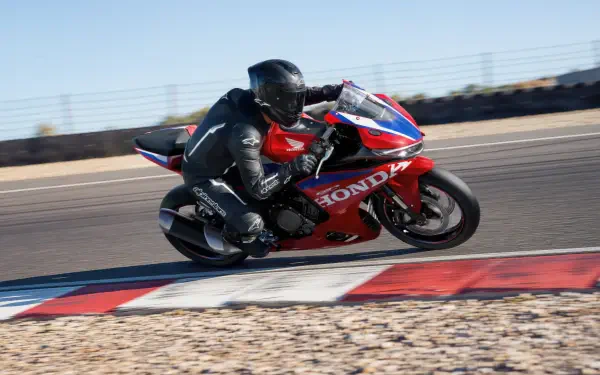 Honda CBR500R Four racing motorcycle on a track, featured in a 5K Ultra HD PC desktop wallpaper and background.