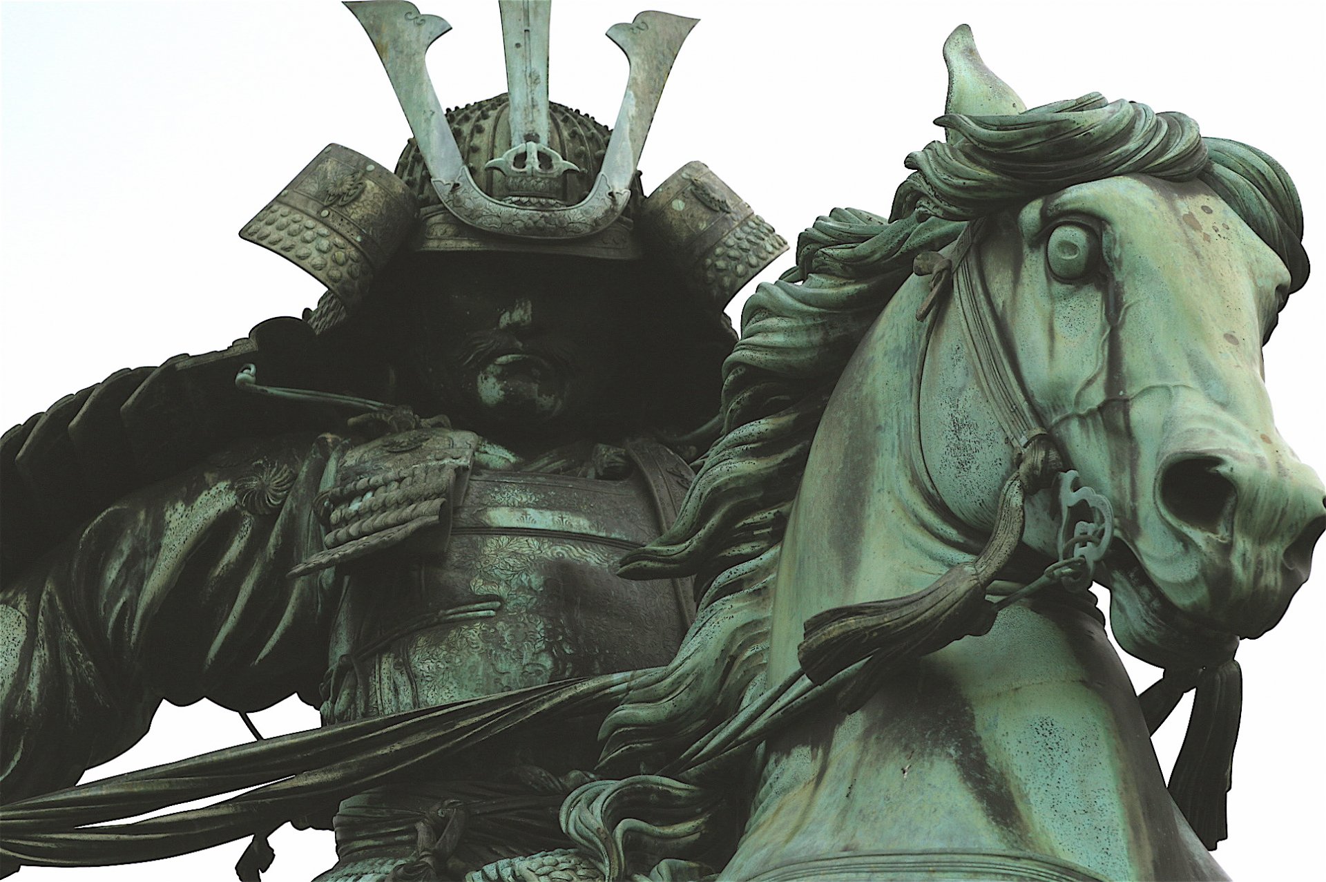 HD desktop wallpaper showcasing a detailed man-made statue of a samurai warrior mounted on a horse, highlighting intricate armor and expressive horse features.