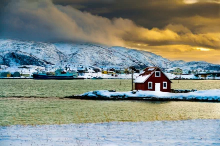HD PC desktop wallpaper and background: snowy coastal town with a man-made red house on a tiny island, boats and buildings across icy water beneath dramatic golden clouds.