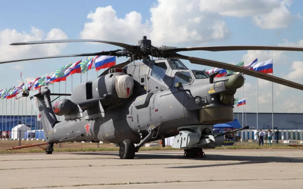 4K Ultra HD image of a Russian Mil Mi-28 military helicopter stationed on a tarmac with multiple Russian flags in the background under a partly cloudy sky.