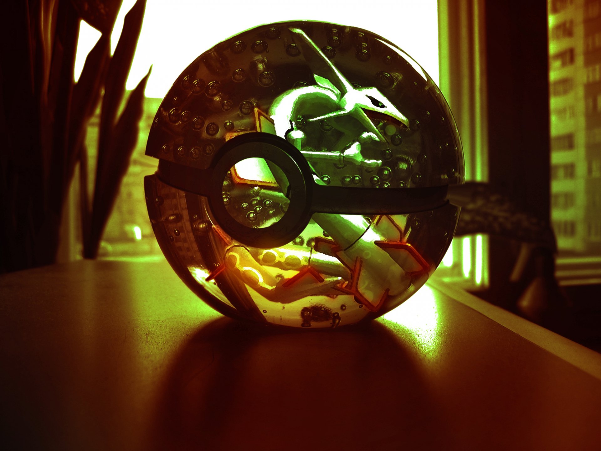 HD PC desktop wallpaper featuring a fantasy-themed Pokemon Pokeball with silhouettes of legendary Pokemon inside, set against a warm, glowing background.