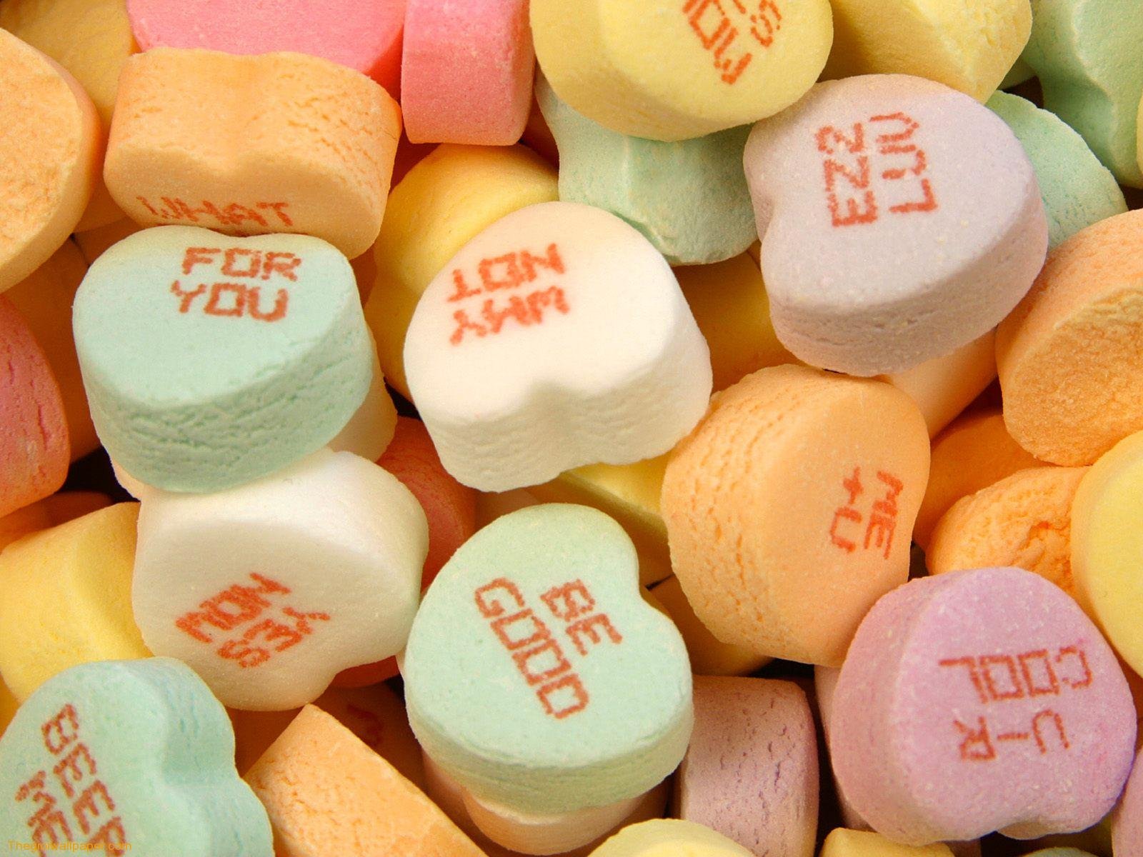 Artistic close-up of colorful love heart candies with sweet messages, designed as an HD PC desktop wallpaper background.