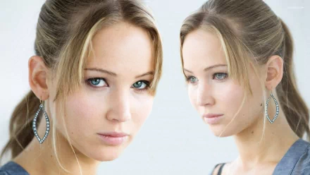 A captivating HD desktop wallpaper featuring Jennifer Lawrence, showcasing her striking blue eyes and elegant hairstyle in a stylish close-up.