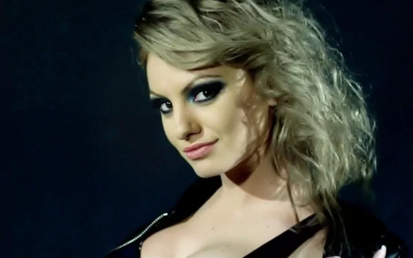 HD PC desktop wallpaper featuring Alexandra Stan with dramatic makeup and styled hair, representing music and dynamic stage presence.
