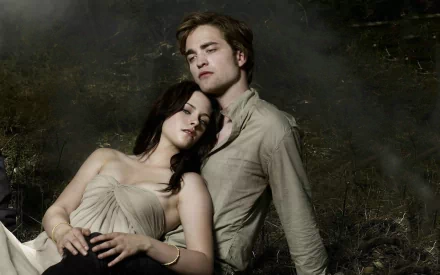 Bella Swan and Edward Cullen relax in a serene, moody scene from the Twilight movie, featuring Robert Pattinson and Kristen Stewart as they embody their iconic characters.