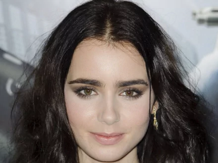 Close-up of Lily Collins, showcasing her striking features and dark hair, serves as an engaging HD desktop wallpaper and background for fans of the celebrity.
