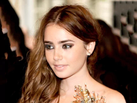 A close-up of Lily Collins, featuring her long, wavy hair and striking makeup. This HD image serves as a stylish desktop wallpaper and background.