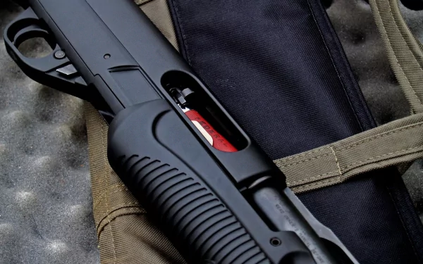 HD PC desktop wallpaper featuring a close-up of a man-made shotgun resting on tactical gear, highlighting the weapon's details and craftsmanship.