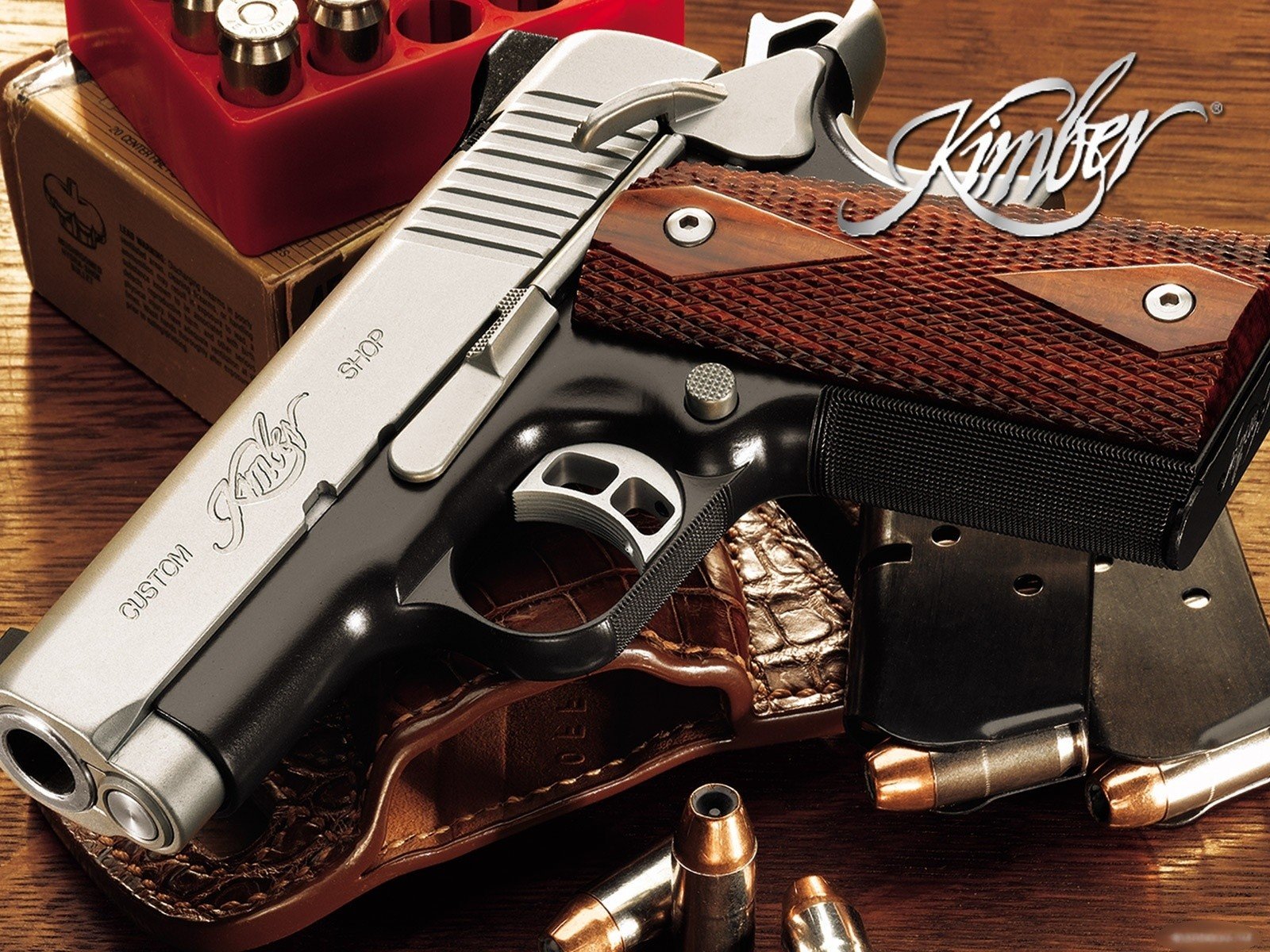 HD desktop wallpaper featuring a detailed close-up of a man-made Kimber pistol with wooden grips and nearby ammunition on a wooden surface.