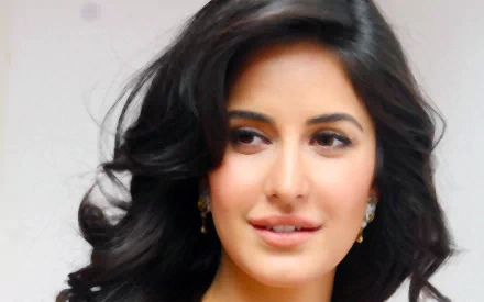 HD desktop wallpaper and background featuring Indian actress Katrina Kaif, showcasing an elegant portrait with her long, dark hair styled in soft curls.