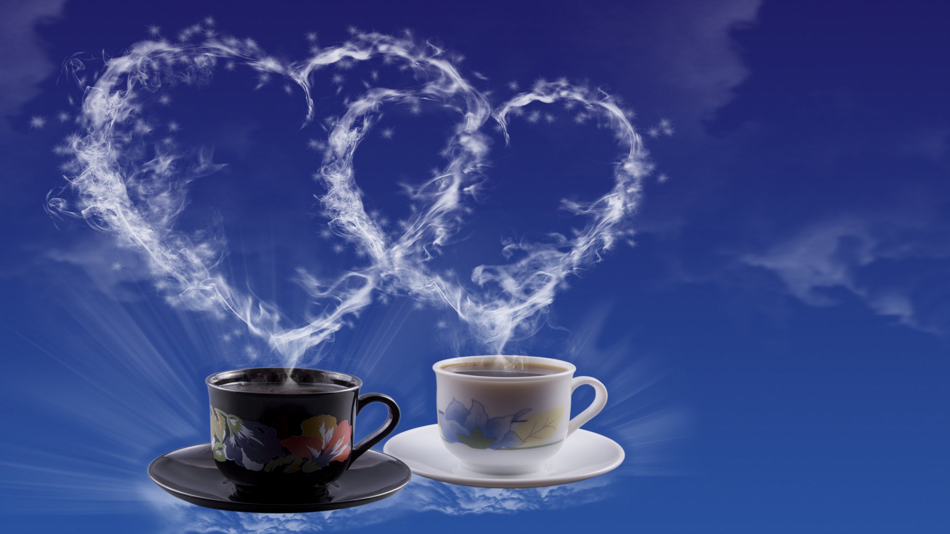 Two coffee cups sit on saucers, with steam rising in the shape of hearts against a serene blue background, creating a warm and inviting atmosphere in this HD desktop wallpaper.