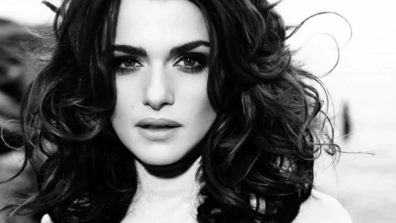 Black and white HD desktop wallpaper of celebrity Rachel Weisz with voluminous hair and a serious expression, showcasing a close-up portrait.
