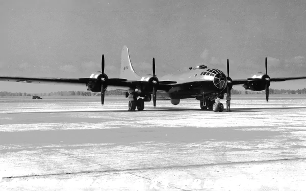 Black and white HD desktop wallpaper of a Boeing B-29 Superfortress military aircraft on a snowy runway.