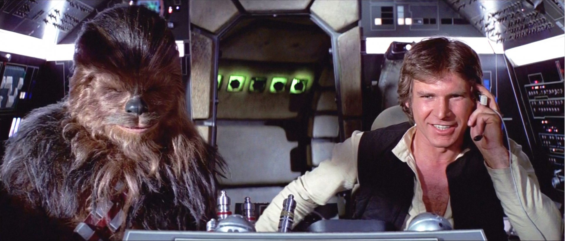 Chewbacca and Han Solo, portrayed by Harrison Ford, sit together in the cockpit of the Millennium Falcon in this vibrant Star Wars HD desktop wallpaper.