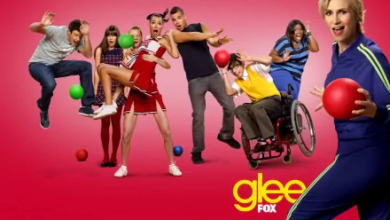 HD PC desktop wallpaper featuring the main cast of the TV show Glee, posed dynamically against a pink background with colorful balls and the Glee FOX logo.