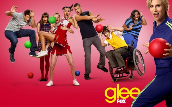 HD PC desktop wallpaper featuring the main cast of the TV show Glee, posed dynamically against a pink background with colorful balls and the Glee FOX logo.