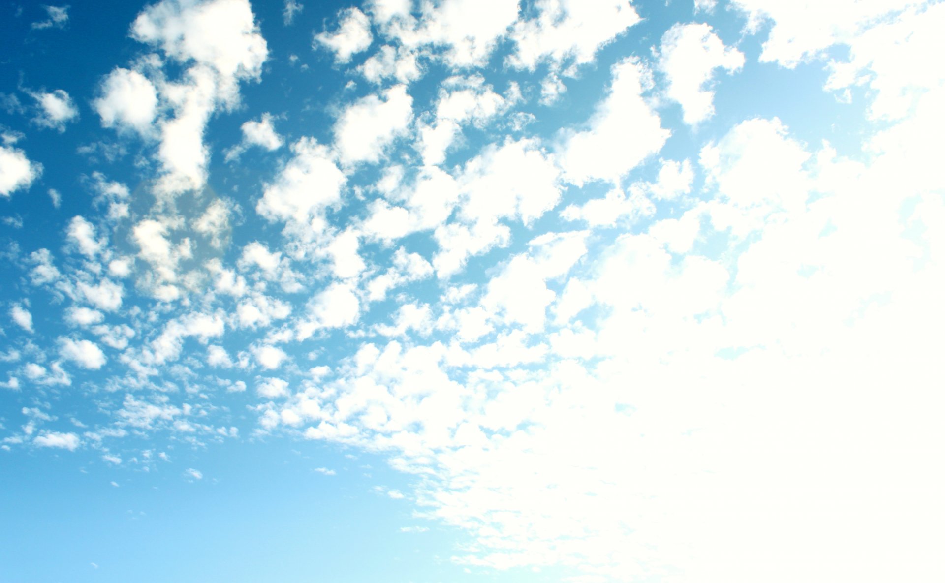 Blue sky speckled with white clouds — 4K Ultra HD nature scene, PC desktop wallpaper and background.