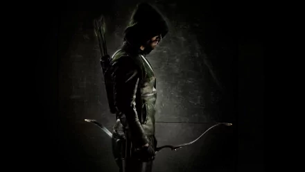 HD desktop wallpaper featuring Stephen Amell as Green Arrow from the TV show Arrow, standing with a bow and arrows against a dark background.
