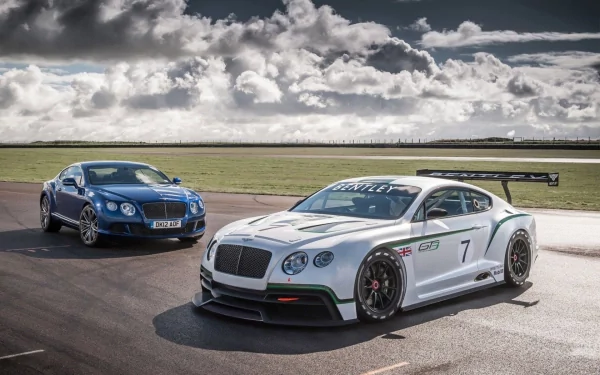 HD PC desktop wallpaper featuring two sleek Bentley vehicles parked on a racetrack under a dramatic cloudy sky.