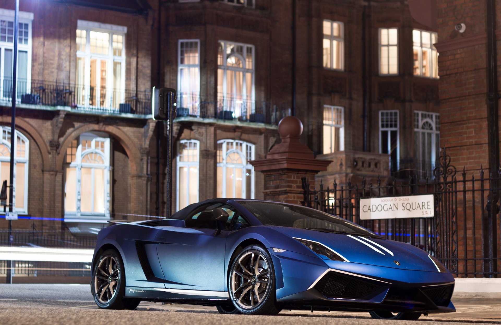 A sleek blue Lamborghini Gallardo parked on a street at night, captured in high detail as a 4K Ultra HD PC desktop wallpaper background.
