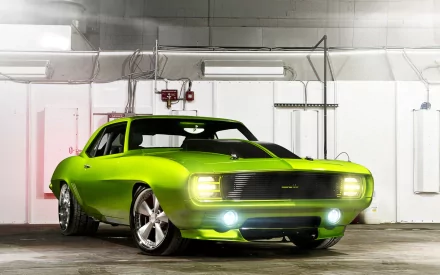 Bright green Chevrolet Camaro with headlights on parked in a concrete garage, HD PC desktop wallpaper/background