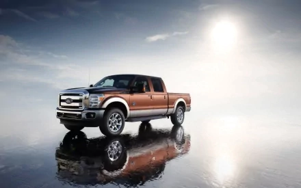 A Ford Super Duty truck is showcased on a reflective surface under a cloudy sky, captured in an HD PC desktop wallpaper background.
