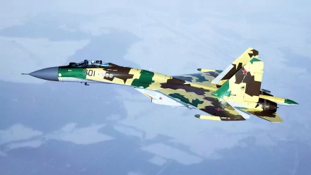 A Sukhoi Su-35 warplane soars through the sky, showcasing its striking camouflage design. This HD wallpaper captures the essence of modern military aircraft.