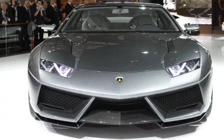 Front view of a silver Lamborghini Estoque on display, HD PC desktop wallpaper/background showing sharp LED headlights, angular grille and glossy metallic finish.