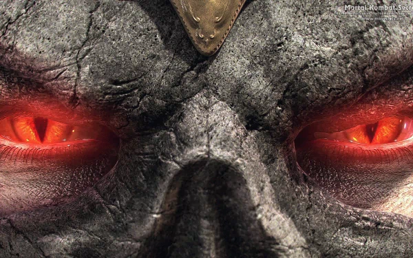 Close-up of Shao Kahn's cracked skull mask and blazing red eyes from the Mortal Kombat 9 video game — dark, textured HD PC desktop wallpaper/background.