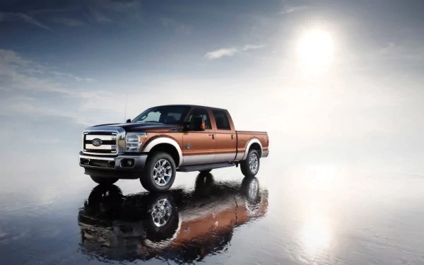 A Ford Super Duty truck is showcased on a reflective surface under a cloudy sky, captured in an HD PC desktop wallpaper background.