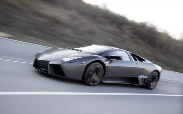 HD desktop wallpaper showcasing a sleek Lamborghini Reventon speeding along a mountainous road.