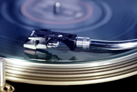A close-up of a vinyl record and turntable arm captures the essence of music and DJ culture, making for a striking HD desktop wallpaper and background.