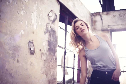 HD PC desktop wallpaper featuring a woman, Rachel Ann Yampolsky, posing gracefully in a softly lit, rustic indoor setting with worn walls and large windows.