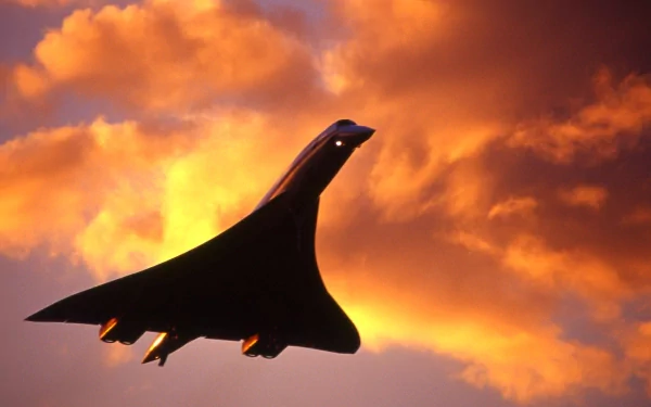 HD desktop wallpaper featuring a sleek aircraft silhouetted against a dramatic orange and yellow sunset sky.
