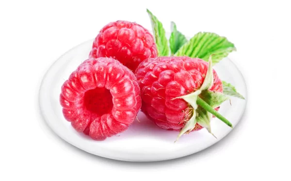 Close-up of fresh raspberries with green leaves on a white plate, captured in high definition for a vibrant PC desktop wallpaper background.