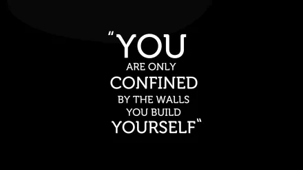 A motivational HD desktop wallpaper featuring the quote, You are only confined by the walls you build yourself, on a black background.