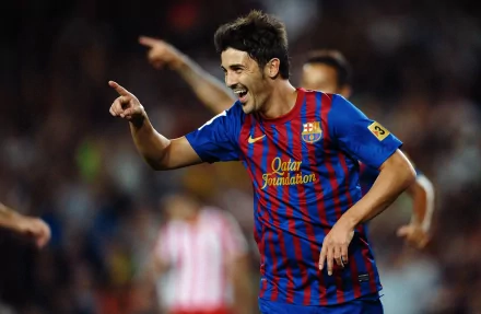HD PC desktop wallpaper showing a jubilant FC Barcelona player in blue-and-red kit celebrating a goal on the pitch.
