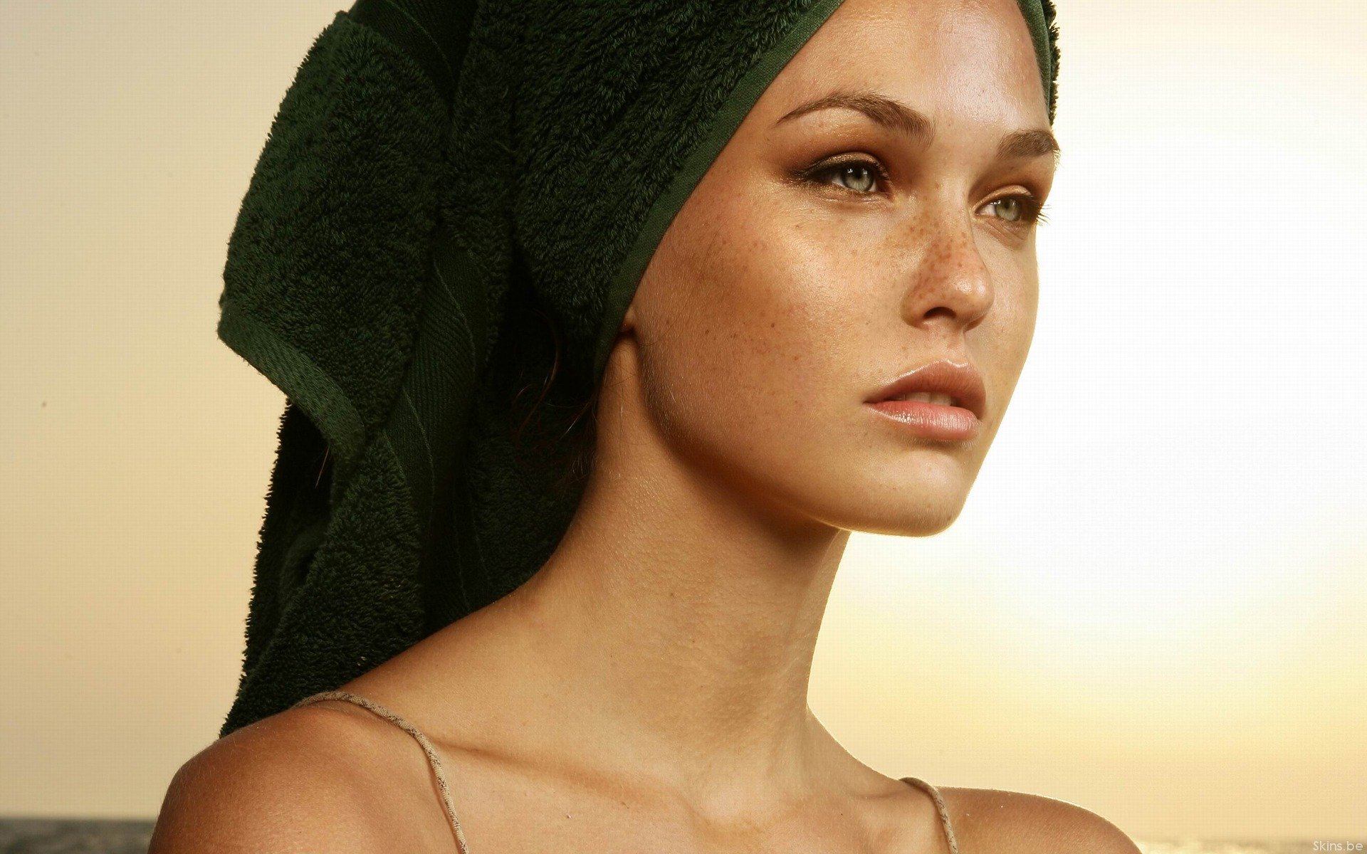 HD desktop wallpaper of celebrity Bar Refaeli with a serene expression, wearing a dark green headscarf against a soft, warm background.