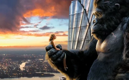 A dramatic HD wallpaper from King Kong (2005), featuring the colossal gorilla holding a woman against a stunning sunset backdrop, capturing the film's iconic tension and beauty.
