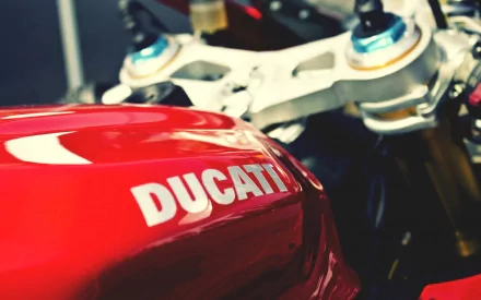 HD desktop wallpaper featuring a close-up of a red Ducati motorcycle's fuel tank and handlebars.