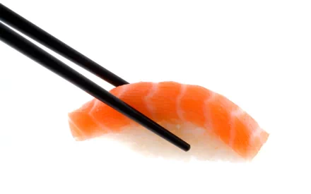 HD PC desktop wallpaper showing a close-up of chopsticks holding a piece of fresh salmon sushi against a clean white background.