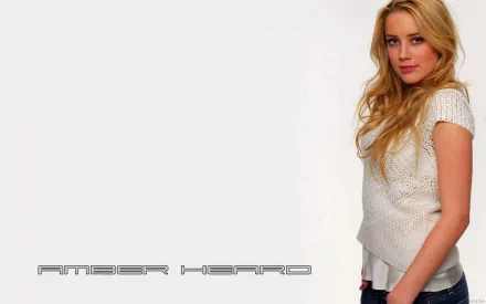 A high-definition desktop wallpaper featuring Amber Heard, showcasing her in a stylish outfit against a minimalist background.