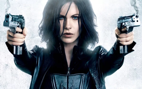 HD PC desktop wallpaper featuring a character from the movie Underworld: Awakening, holding two guns and staring intensely forward.