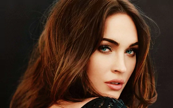 HD desktop wallpaper featuring a close-up portrait of Megan Fox with her hair cascading over her shoulder, confidently looking at the camera.