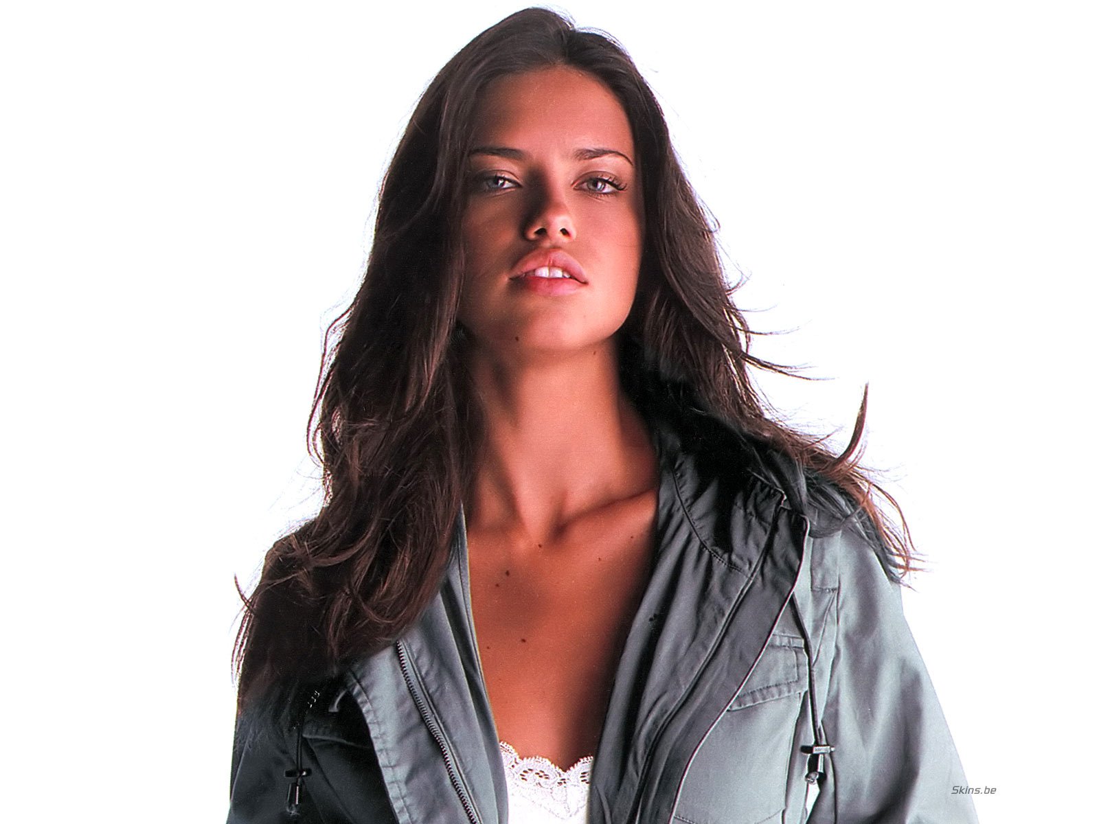 HD wallpaper featuring celebrity Adriana Lima, showcasing her confident pose and stunning features against a clean white background.