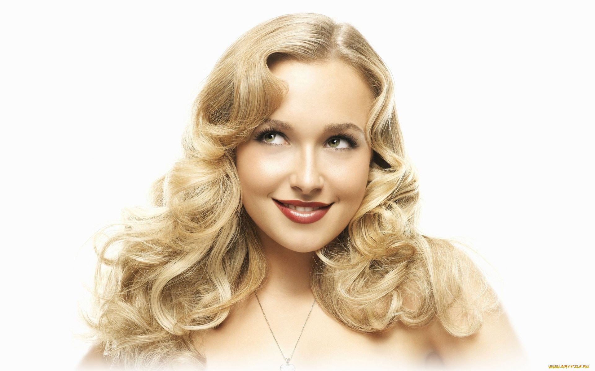 HD desktop wallpaper featuring celebrity Hayden Panettiere with styled blonde hair and a warm smile against a clean white background.