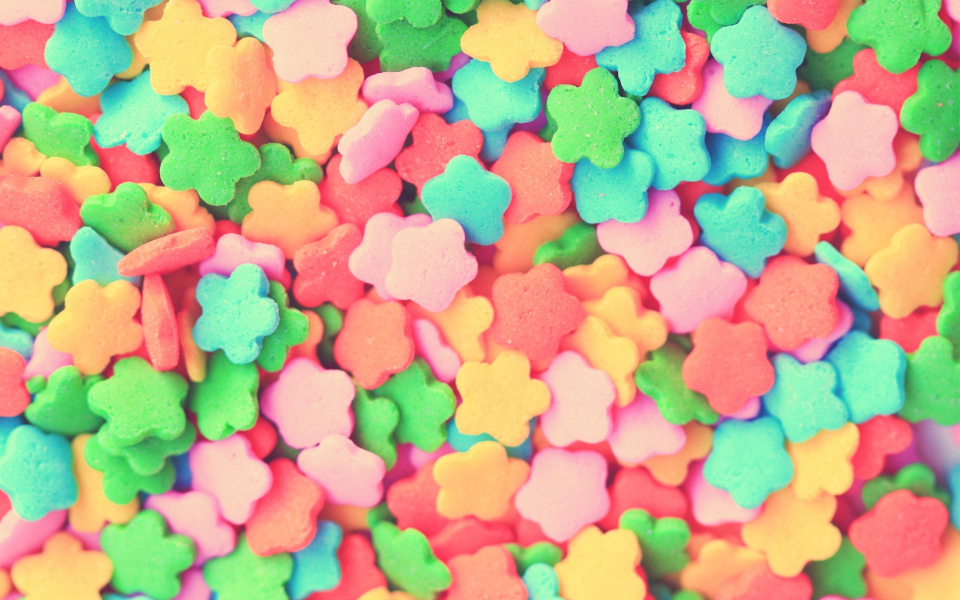 Colorful flower-shaped candy pieces create a vibrant and playful HD PC desktop wallpaper and background.