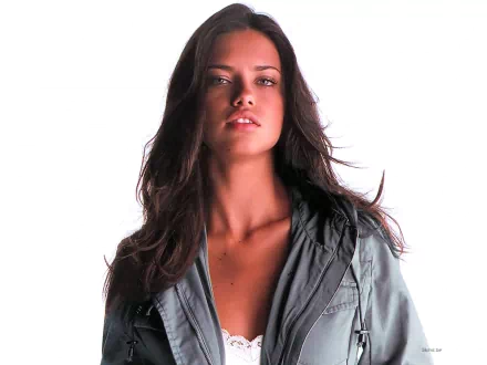 HD wallpaper featuring celebrity Adriana Lima, showcasing her confident pose and stunning features against a clean white background.