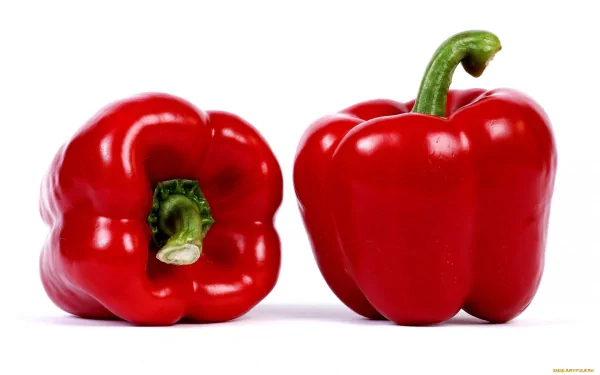 HD desktop wallpaper featuring two vibrant red bell peppers on a white background, highlighting fresh food’s natural color and texture.